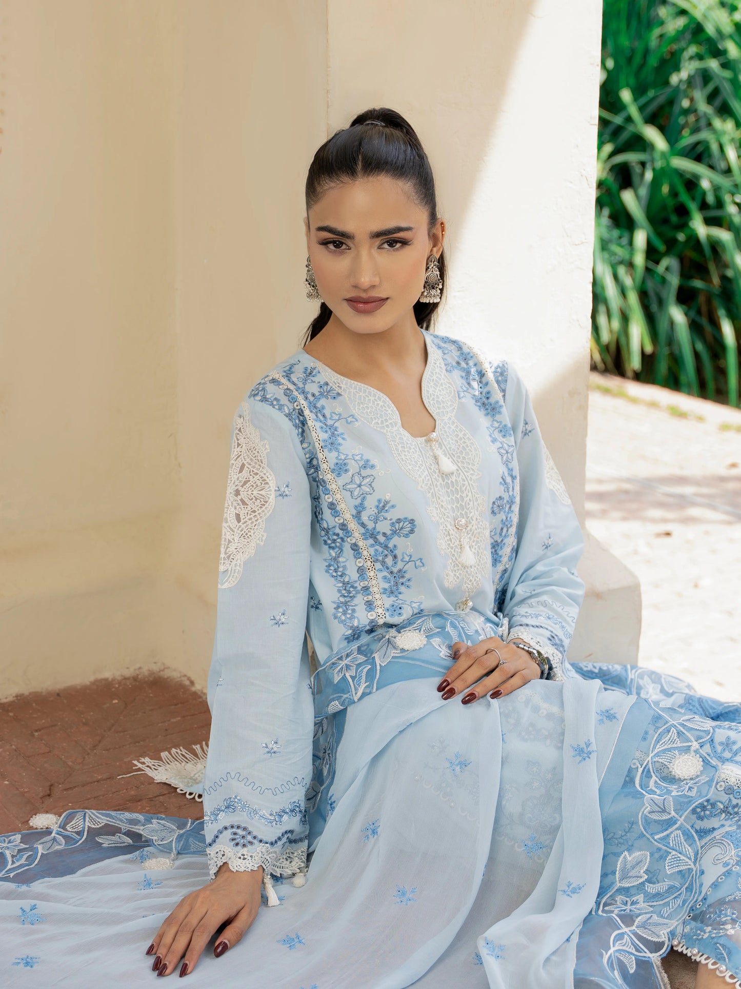 Opal Sky Luxury Lawn Suit Seated Pose – Sky Blue 3PC Embroidered Suit with Chiffon Dupatta, Lace Sleeves and Fringe Hem | Wirsa