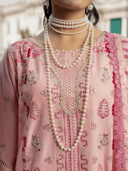 A close-up of a person wearing a light pink embroidered traditional outfit with intricate floral and geometric patterns, layered with multiple strands of long pearl necklaces.
