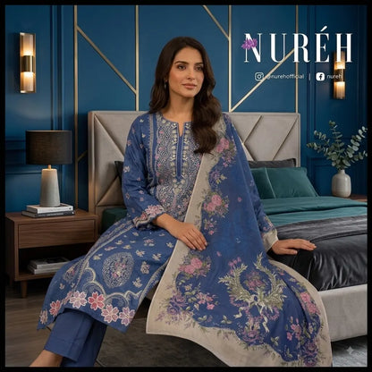 A woman models a blue traditional South Asian salwar kameez suit with intricate white embroidery and a matching dupatta featuring floral prints, set in a modern bedroom with blue walls and gold accents.
By WirsaFabric